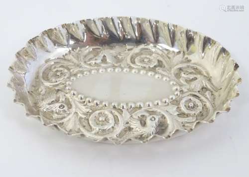 A Victorian silver pin tray with embossed decoration hallmarked London 1883 maker Holland,