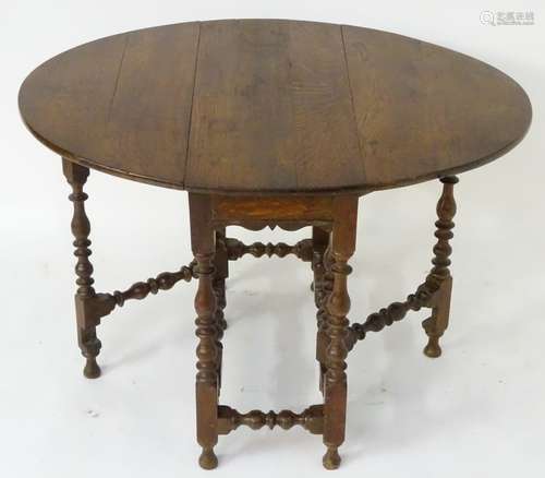 A mid 18thC oak gateleg table opening to form an oval top,