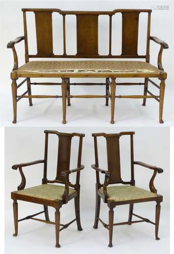 A Richard Norman Shaw Tabard suite comprising two open armchairs and a settee,