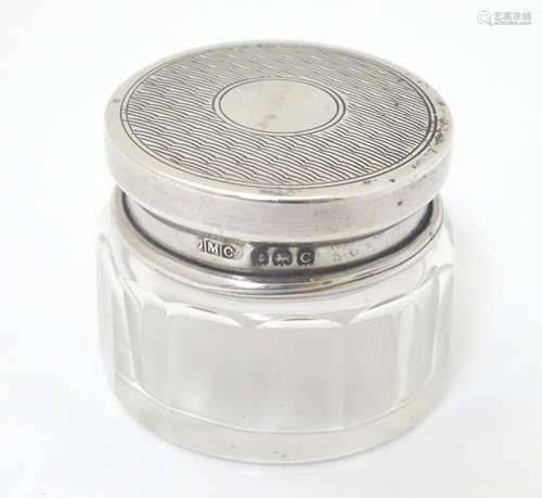 A small glass pot with silver top, hallmarked Birmingham 1927, maker JMC. Approx.