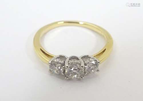 An 18ct gold ring set with trio of diamonds. Ring size approx. N.