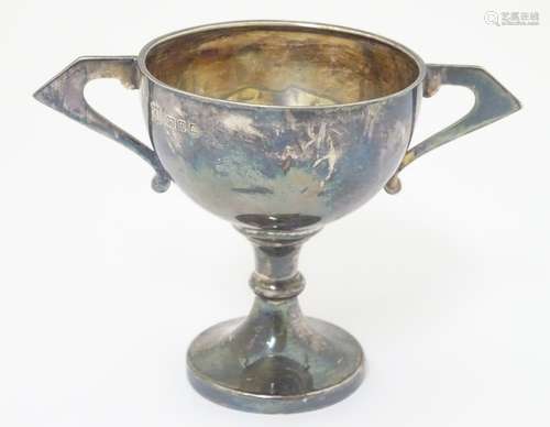 An Art Deco silver trophy cup of pedestal form with twin handles, hallmarked London 1936,