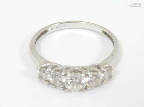 A 14ct white gold ring set with 5 graduated cubic zirconia. Ring size approx.