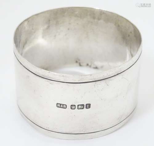 A silver napkin ring, hallmarked Sheffield 1911, maker Roberts & Belk.