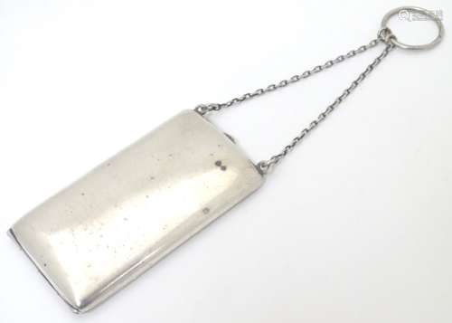 A small silver cheroot case with hanging chain.