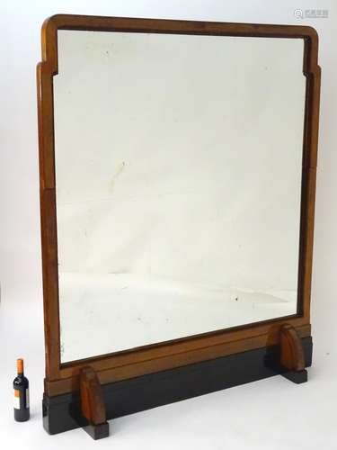 A large mid 20thC Art Deco mirror with a walnut and ebonised frame.