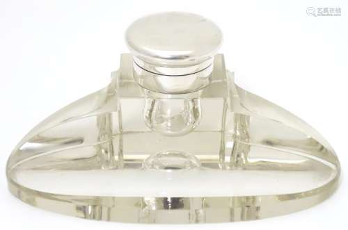A glass standish / inkwell of ovoid form, with pen rest and silver mounted and lidded inkwell,