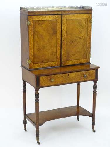 A Regency bonheur du jour with a brass gallery above a crossbanded top and two marquetry decorated