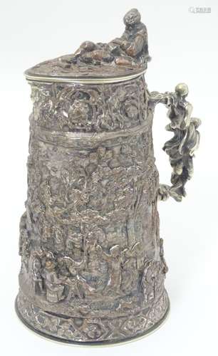 A 19thC silver plate stein with cast decoration end engraved armorial to hinge of lid.