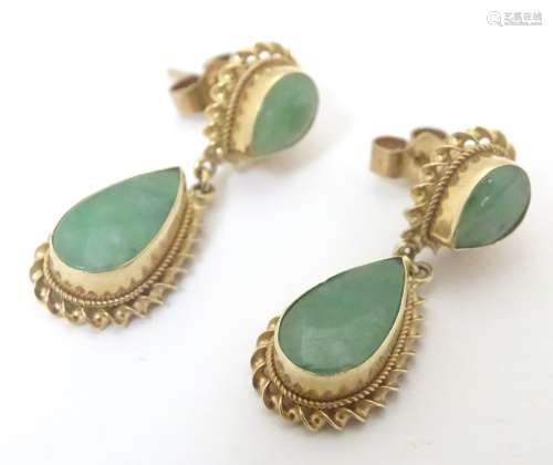 A pair of 9ct gold drop earrings set with jade pear shaped stones. Approx.