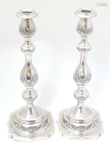 A pair of silver candlesticks with engraved decoration. Hallmarked London 1929 maker M.S.