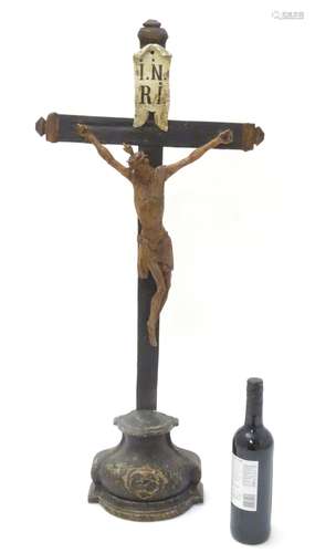 A large 19thC polychrome crucifix with an I. N. R. I.