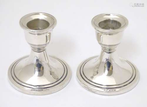 A pair of silver candlesticks hallmarked Birmingham 1962 maker Sanders & Mackenzie 2 1/2