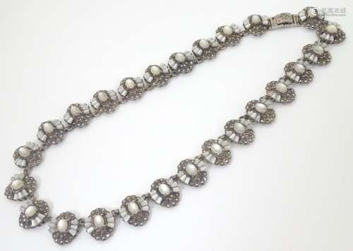 A silver necklace formed from 25 vignettes each set with a profusion of marcasites and with catseye