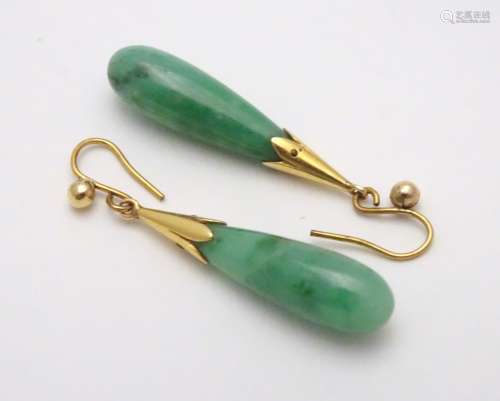 A pair of jade drop earrings with 9ct gold mounts. The earrings approx.