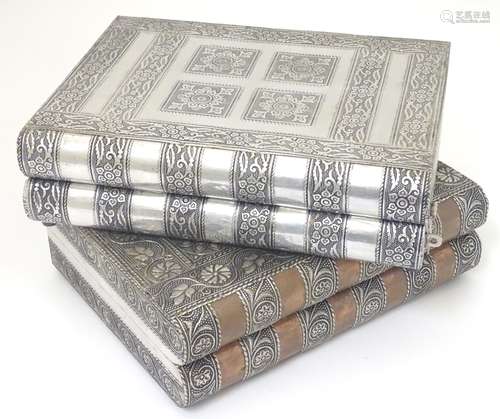 Two jewellery boxes formed as bound books with embossed white metal decoration.