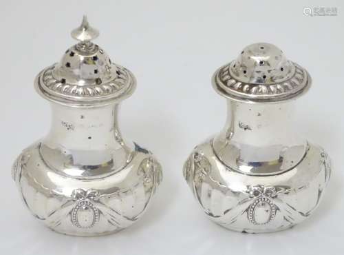 A pair of silver salt and pepper pots Hallmarked Birmingham 1900 maker Mappin & Webb Ltd.