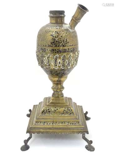 A late 19thC Indian brass hookah pipe base with black enamel and engraved scrolling foliate