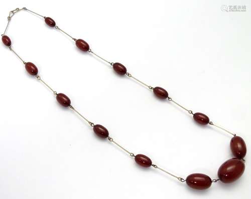 A Vintage necklace set with graduated cherry amber coloured beads 18