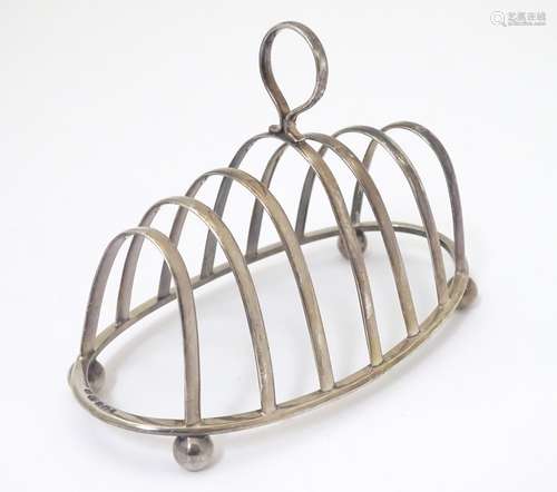 A silver 7-bar toast rack hallmarked Sheffield 1913 maker Joseph Rodgers & Sons Ltd.