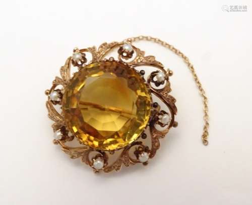 A 9ct gold brooch set with central facet cut citrine,