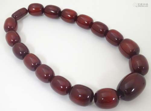 A vintage necklace of red cherry amber coloured graduated beads.