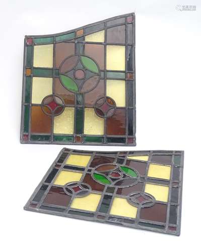 A pair of early 20thC lead and stained glass window / door panels, of irregular quadrilateral form,