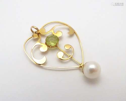 A 9ct pendant set with peridot and pearl drop in the Art Nouveau style 1 1/2