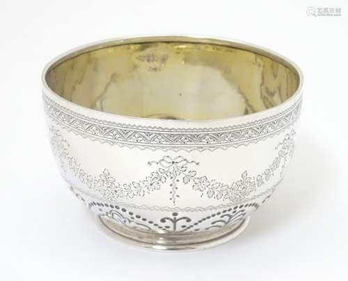A Victorian silver bowl with engraved and punch work decoration.