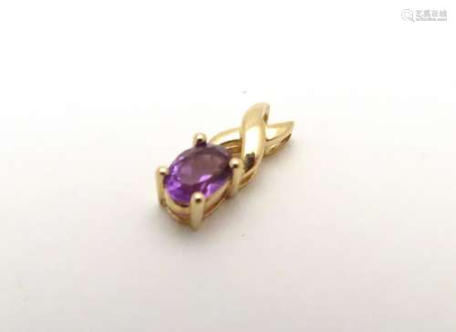 A 9ct gold pendant set with oval cut amethyst. the stone 1/4