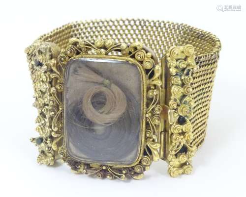 Mourning / Memorial jewellery : A 19thC gold and gilt metal mourning bracelet of cuff form with