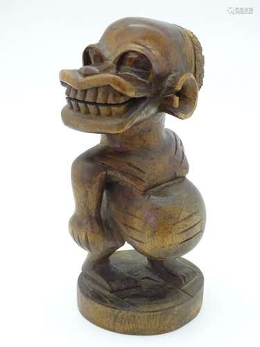 Ethnographic / Native / Tribal: A carved wooden native figure on a circular base. Approx.