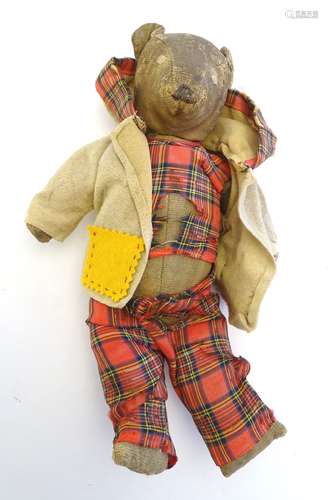 Toy: An early 20thC straw filled teddy bear, with a stitched mouth, nose and eyes. Approx.