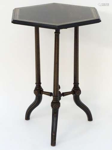 A late 19thC ebonised Aesthetic movement coromandel table with a hexagonal top,