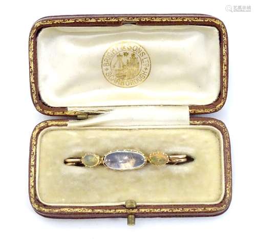 A Victorian yellow metal (tests as gold) brooch set with moonstone and opals.