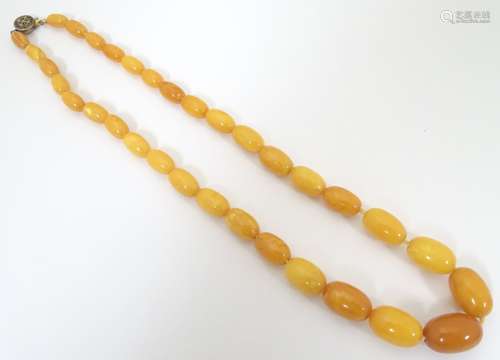 A vintage necklace of graduated butterscotch amber coloured beads. The largest bead 3/4