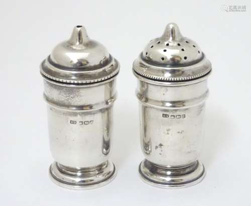 A pair of silver salt and pepper pots hallmarked Sheffield 1936 maker Viner's Ltd.