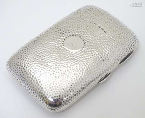 A silver cigar case with hammered decoration hallmarked Birmingham 1906 maker Thomas Bishton.