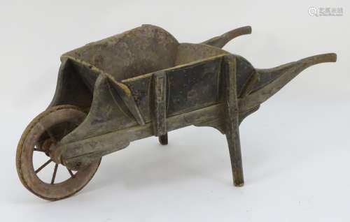 A late 19thC small wheelbarrow, of pine construction with painted finish, marked 'W.R.G.C.