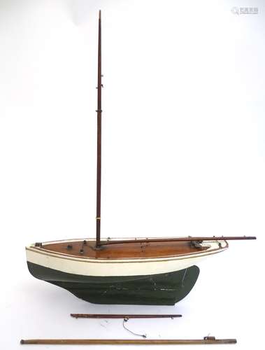 Toy: An early 20thC painted wooden toy boat / pond yacht. Approx. 22