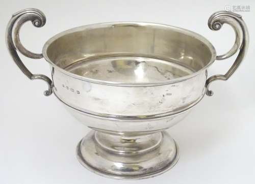 A large silver bowl with twin handles hallmarked Birmingham 1921 maker William Aitken.