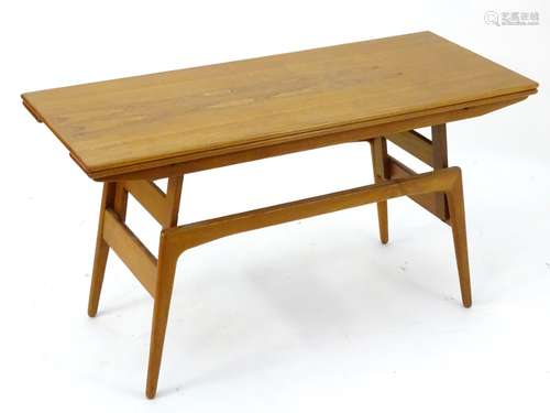 A vintage retro metamorphic low/dining table, of teak construction,