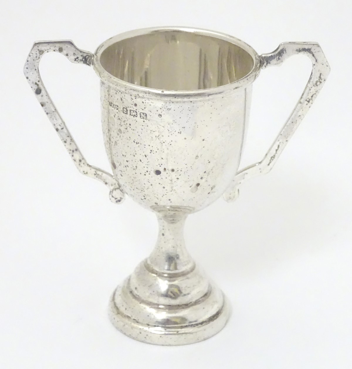 A silver trophy cup of pedestal form with twin handles. Birmingham