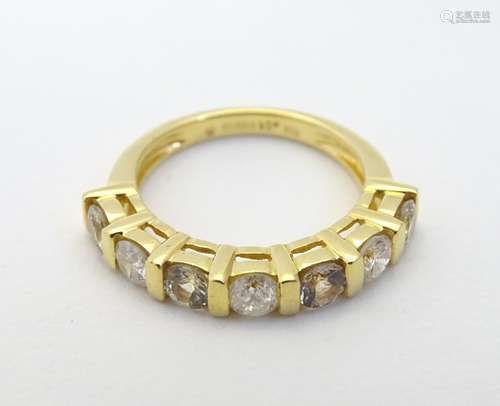 An 18ct gold ring set with diamonds and yellow stones in a linear setting Ring size approx.