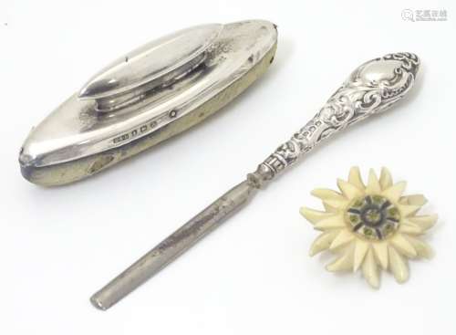 A silver handled nail buffer together with a silver handled manicure tool.