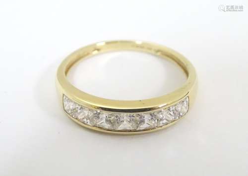 A 14ct gold ring set with 7 cubic zirconia in a linear setting. Ring size approx.