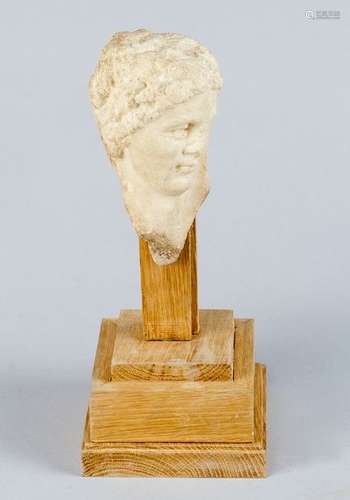 Roman bust of a man with curled hair, sculpted whi…