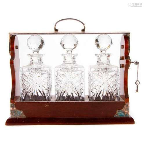 A locking Tantalus decanter set.