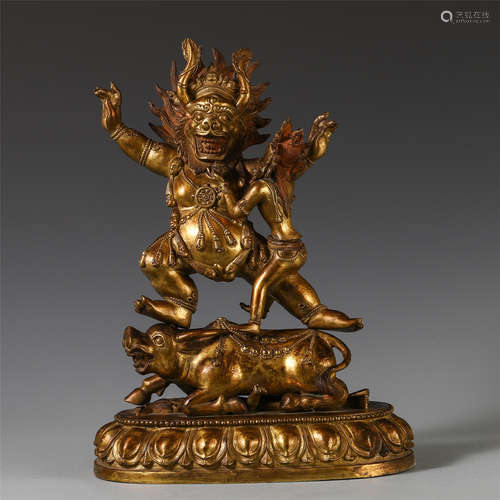 A CHINESE GILT BRONZE MAHAKALA STANDING ON BEAST