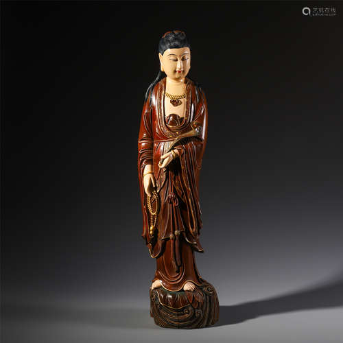 A CHINESE WOOD PAINTED GUANYIN STANDING WITH BEADS AND RUYI IN HAND